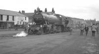 <I>The Dalesman</I> railtour of 4 May 1963 was organised by the RCTS West Riding branch and hauled throughout by 3442 <I>The Great Marquess</I>.  Starting and finishing at Bradford Forster Square the special visited various branches in Yorkshire and Lancashire. 3442 is seen here running round at the terminus at Barnoldswick (colloq. <I>Barlick</I>) where, in the absence of on-train dining facilities, the opportunity to purchase one of the renowned <I>Stanley's Crumpets</I> was doubtless greatly appreciated by many of the participants.<br>
<br><br>[K A Gray 04/05/1963]