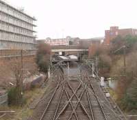 Bury Interchange, now over thirty years old, as seen from an ELR train passing over <I>The Hump</I> on the Heywood line that replaced the flat crossing at Bury Knowsley Street. Originally used by Bury line EMU services the Interchange was converted to Metrolink operation in 1992 and a tram can be seen in one of the platforms. The pointwork in the foreground is needed for the six minute frequency service that is in operation on most days. [See image 24666] <br><br>[Mark Bartlett 01/01/2011]
