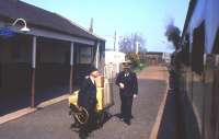Classic BR uniforms glimpsed at Ellon from the 12.25 Aberdeen-Fraserburgh train on Saturday 1st May 1965, with driver and secondman hanging out of the NBL Type 2 at the front (yes, a diesel locomotive). The Station Master - identified by the copious gold braid - is Alastair Farquhar, who hailed from Buckie. He had previously been based at lonely Riccarton Junction, and would face yet more change in five months' time when passenger trains were withdrawn from the Fraserburgh and Peterhead lines. [With thanks to Bruce McCartney]<br><br>[Frank Spaven Collection (Courtesy David Spaven) 01/05/1965]