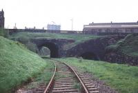 View west from the site of Greenock Lynedoch station in June 1969. Scheduled passenger services over this route, which ran to Princes Pier, were withdrawn in 1959, although boat train traffic continued until 1965. It was used latterly to handle container traffic, prior to final closure in 1991. The line through the bridge to the right ran to the large Lynedoch goods depot which was located at a lower level and is now the site of Lynedoch Industrial Estate. <br><br>[Colin Miller /06/1969]