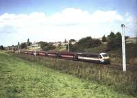 A Virgin West Coast service, comprised of mixed liveried stock, heads south on the WCML at Farington Curve Junction in September 1999. The DVT at the front and class 87 on the rear are still in <I>InterCity</I> livery while the entire rake of coaches has been rebranded in Virgin colours.<br>
<br><br>[John McIntyre /09/1999]