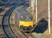 Looking through the OHLE as 150134 heads south of Skew Bridge <br>
towards Farington Curve Junction with a Preston to Hazel Grove service on 21 January 2011.<br>
<br><br>[John McIntyre 21/01/2011]
