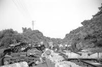 Clearance of wreckage and replacement of damaged track in progress in the cutting east of Grantshouse station following the Freightliner derailment of 15 July 1969 [see image 32491]. Photographed looking east into the cutting during the evening of the day following the crash. Clearance and relaying work had been completed by Saturday 19 July when normal operations were resumed.<br>
<br><br>[Bill Jamieson 16/07/1969]