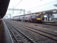 View north at Nuneaton in February 2011 as a CrossCountry service from Stansted Airport to Birmingham New Street calls at the station's new east side island platform. After leaving, 170107 will then climb to cross the WCML flyover in the distance before turning west towards Birmingham.<br><br>[Mark Bartlett 23/02/2011]