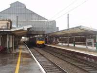 Preston's impressive trainshed, or at least the western half of it, as seen from the north end of Platform 3. 150146 has just arrived in Platform 2 on the hourly Blackpool North to Liverpool Lime Street service. <br><br>[Mark Bartlett 26/01/2011]