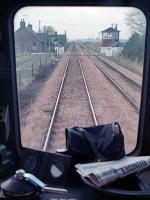 A view from an eastbound DMU approaching Inchture Level Crossing in January 1989. The box was subsequently demolished. The driver's newspaper provides an alterative destination blind!<br><br>[Ewan Crawford 25/01/1989]