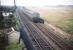 A DMU on the Troon avoiding line approaching Lochgreen Junction on what appears to be an ECS working if the 'C' headcode is to be believed (there were few passenger trains that used the line  avoiding Troon station). The photographer is standing on the overbridge that still exists, with the Lochgreen municipal golf course off to the right. Lochgreen Junction's up main starting signal lattice post can be seen behind the double framed telegraph pole. The nomenclature of the lines in the days that this photo appears to have been taken (around 1959/60) was the avoiding lines were the 'main lines' and the lines via Troon passenger station the 'branch lines'.<br><br>[A Snapper (Courtesy Bruce McCartney) //1959]