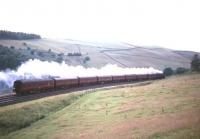 A down train passing through Drumlanrig Gorge north of Enterkinfoot in the 1960s. The locomotive is thought to be <I>Jubilee</I> 4-6-0 no 45593 <I>Kolhapur</I> [see image 21886].<br><br>[Robin Barbour Collection (Courtesy Bruce McCartney) //]