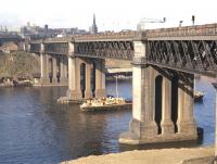 The King Edward Bridge as seen in mid-afternoon from thesouth bank of the Tyne at the very end of September 1970. (The picture was taken as a record of the bridge rather than as a photograph of thetrain of vans, which is headed by class 37 no 6874.)<br><br>[Bill Jamieson 30/09/1970]