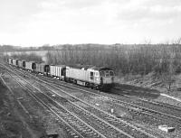 33102 passing Fairwood Junction, Westbury, in February 1990 with a stone train from the Somerset quarries. The train is heading into the Westbury marshalling yards. <br><br>[Peter Todd 21/02/1990]