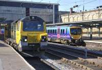 First TransPennine 185 139leaves Carlisleon 18 March withthe 14.07 Edinburgh Waverley -Manchester Airport service. Standing at platform 3 is Freightliner 70006 waiting to follow it south.<br><br>[Bill Roberton 18/03/2011]