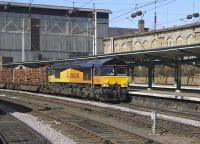 Colas Rail 66843 runs through Carlisle with the 6J37 Kingmoor - Chirk timber train on 19 March 2011.<br><br>[Bill Roberton 19/03/2011]