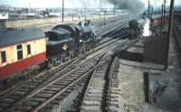 Comings and goings at Craigentinny carriage sidings in September 1959 with Ivatt 2-6-0 no 46461 arriving as B1 4-6-0 no 61007 <I>Klipspringer</I> awaits the road to Waverley station with the stock of <I>The Talisman</I>. <br><br>[A Snapper (Courtesy Bruce McCartney) 30/09/1959]