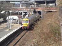 Spring sunshine and the birds are twittering in Dennistoun on the <br>
morning of 26 March as 334 030 calls at Bellgrove, heading east.The<br>
fact that it's a 334 means it's more likely to be an Edinburgh service than a local and indeed it is.<br>
<br><br>[David Panton 26/03/2011]