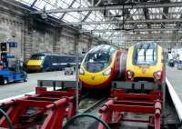 A scene doomed by the timetable changes to come - the 09.50 for Kings Cross with 91113 propelling, alongside a Euston Pendolino and a Birmingham Voyager at Glasgow Central on 31 March 2011. <br><br>[Colin Miller 31/03/2011]