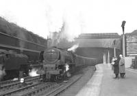 46239 <I>City of Chester</I> storms out ofGlasgow Central with the up 'Mid-day Scot' during the school Easterholidays in 1960. The loco is flanked on the left by an unidentified Fairburn Class 4 2-6-4T while the few enthusiasts on the right are enjoying a spectacle which demonstrates why the steam railway wassurely 'the greatest free show on earth' (discounting the cost of a platform ticket that is!). A historic shot this - my very first attempt at action photography (and probably amongst my first half dozen railway photographs).<br>
<br><br>[Bill Jamieson //1960]