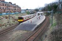 314 208 takes an inner circle service south amongst the tenements of Maxwell Park drawing to a halt at the station of the same name. The park itself is off to the right over Terregles Avenue.<br><br>[Ewan Crawford 27/03/2011]