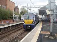 An Edinburgh to Helensburgh service, formed by Saltire liveried 334006, pauses at Coatbridge Sunnyside after a run along the new <I>A to B line</I>. Resurfacing and other work was taking place on the car park and station forecourt here on this date. <br><br>[Mark Bartlett 14/04/2011]