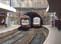 Two Scotrail Class 170s pass in the tunnel mouth at Haymarket. 170418 on the left is heading for Waverley and the approaching 170414 is bound for Dunblane. <br><br>[Mark Bartlett 14/04/2011]