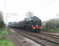 Day 6 of the 2011 <I>Great Britain IV</I> tour sees 46115 <I>Scots Guardsman</I> heading the Glasgow to Preston leg south through the site of closed Bolton-le-Sands station after an extended water stop at Carnforth.<br><br>[Mark Bartlett 21/04/2011]
