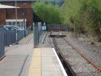 'Lines end' at Maesteg in April 2011, with a detached buffer assembly and chained sleepers acting as a stop barrier. The old trackbed beyond is well used to access Asda and the town using a gap created in the palisade fence behind the trees on the right, and then walking alongside the fence on left to access the platform via the ramp.<br><br>[David Pesterfield 20/04/2011]