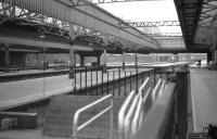 View from behind the buffers on the former platform 13 at Aberdeen on 9 June 1973 looking north with platforms 12, 11 and 10 to the left. The platform canopies remain on this side of Guild Street bridge but on the far side they have all been demolished. Today (2011) you would be looking under Atholl House. [See image 12310] for the view back from Guild Street Bridge into the station 33 years later.<br><br>[John McIntyre 09/06/1973]