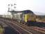 Class 37 No. 6839 passes Niddrie West signal box andtakes the line to Niddrie South with a rake of empty 16t mineral wagons in October 1970. The trainis thought to be the 10.15 Mossend - Millerhill Yard. It is definitely not the 11.38 Ravenscraig No. 2 toCarlisle Yard which reported as 8M16. In all probability the loco hadbeen to Carlisle and back the previous day and nobody had changed the reporting number for this trip.<br><br>[Bill Jamieson 13/10/1970]