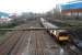 An outer circle service takes the Cathcart Circle at Muirhouse North Junction and prepares to stop at Pollokshields East. The two used tracks to the left are the route to Barrhead and Kilmarnock and the disused single track further left is the remains of the C.E. Yard (formerly carriage sidings and once a timber yard). March 2011.<br>
<br><br>[Ewan Crawford 27/03/2011]