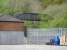 Footbridge and platform at what appears to be the original Maesteg station site located some 100 metres beyond the present location, as seen from the Asda service yard on 20 April. The old trackbed is well used as a shortcut to the current station [see image 33866].<br><br>[David Pesterfield 20/04/2011]