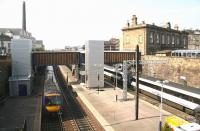 View west over Haymarket station on 21 April 2011 showing the newly commissioned lifts now providing disabled access to platforms 2,3 and 4. A Waverley - Queen Street shuttle has just arrived at 4 while the 09.52 Aberdeen - Kings Cross HST is in the process of leaving platform 1. <br><br>[John Furnevel 21/04/2011]