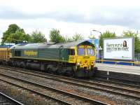 <I>There's no answer to that...</I> Freightliner 66607 looks puzzled as it pulls up with a northbound ballast train at Oxford on 17 May for a crew change.<br><br>[Peter Todd 17/05/2011]