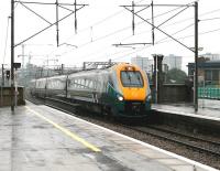 With heavy rain falling over North London on 23 July 2005, a Hull Trains service accelerates through Finsbury Park on the down ECML shortly after leaving Kings Cross. Meantime, in the left background, construction work continues on Arsenal FC's new Emirates Stadium. <br><br>[John Furnevel 23/07/2005]