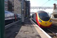 The 09.40 Pendolino for Euston leaves platform 2 of Glasgow Central on 19 May, while the 09.50 service to King's Cross awaits its departure time at platform 1. This view will no longer be possible after tomorrow with the cessation of through East Coast Glasgow - King's Cross services following introduction of the revised timetable.<br><br>[Colin Miller 19/05/2011]