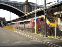 Voyager unit 220023 sits under North Bridge after arrival on platform 8 at Waverley coupled to sister unit 220029 on the 07.03 ex Birmingham New Street Cross Country east coast route service. <br><br>[David Pesterfield 10/05/2011]