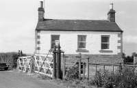 The station house and level crossing gates at Maxton in 1975. View is north towards the village, with the line to St Boswells continuing over the crossing to the left and Roxburgh off to the right. <br>
<br><br>[Bill Roberton //1975]