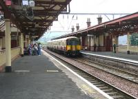 An Airdrie - Helensburgh service arrives at Dumbarton Central station on a fine July morning in 2005.<br><br>[John Furnevel 10/07/2005]