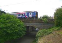 The 12.41 stopping service to Glasgow Central via Shotts leaving Wester Hailes on 31 May 2011. The train is just pulling away from the platform and is about to cross the underpass at the west end of the station.<br><br>[John Furnevel 31/05/2011]