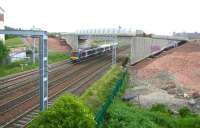 The tram flyover at Saughton looking essentially complete on 31 May 2011 and even possessing its first graffiti. View is from the path up to the footbridge, looking east towards Haymarket, as a Fife bound DMU approaches. [See image 28409]<br><br>[John Furnevel 31/05/2011]