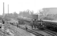 General view of the sidings at Fawley in April 1967 as USA 0-6-0T locomotives 30064+30069 pause to take on water during the LCGB <I>Hampshire Branch Lines Rail Tour</I>. The pair would take the train as far as Totton before handing over to 80151 for the next leg to Brockenhurst and Lymington Pier. <br><br>[Robin Barbour collection (Courtesy Bruce McCartney) 09/04/1967]