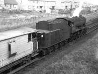 A WD 2-8-0 propelling a brake van from the Darvel direction passing under the bridge at Barleith, by Hurlford shed, in August 1962. Barleith station closed in April 1964.<br><br>[Colin Miller /08/1962]