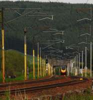 A distant Pendolino appears like a mirage in the heat. The view looks to Beattock Summit.<br><br>[Ewan Crawford 14/06/2011]