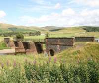 The bridge that once carried the narrow gauge Camps Railway across the River Clyde at Crawford, seen here on 5 August 2009. The 3 ft gauge line was built in the 1920s by Lanarkshire County Council to transport materials required in the construction of Camps reservoir, located amongst the hills in the middle distance. The supply yard and exchange sidings alongside the WCML stood off camera to the right.<br><br>[John Furnevel 05/08/2009]