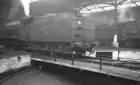 Scene inside Carlisle Canal shed in April 1962. In the picture are J39 0-6-0 no 64895 on the turntable and the rear of Stanier 2-6-4T no 42440 in the background.<br><br>[K A Gray 19/04/1962]