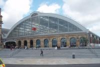 One of the two Lime Street trainsheds fronts directly on to the road outside, while the second is hidden behind a building. Refurbishment has given the station a light and airy feel as seen in this picture. Note the prominent double arrow symbol on the glass screen. <br><br>[Mark Bartlett 24/06/2011]