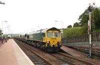 Southbound coal through New Cumnock on 27th June 2011 behind Freightliner 66606.<br><br>[Colin Miller 27/06/2011]