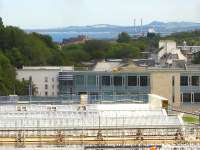 View over the ongoing re-glazing works at Waverley Station and along the Firth of Forth to the twin chimneys of rail served Cockenzie Power Station. The Edinburgh Council offices stand beyond the station.<br><br>[David Pesterfield 24/06/2011]