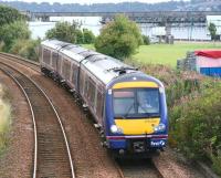 An afternoon Dundee - Glasgow Queen Street service approaches the site of the former Magdalen Green station on 20 September 2007. In the background maintenance work is underway at the north end of the Tay Bridge.<br>
<br><br>[John Furnevel 20/09/2007]