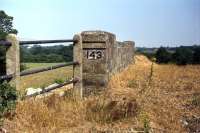 Bridge 143 on the Midland and Great Northern Joint railway was located at Bengate between North Walsham and Honing. This is the view towards Honing on 3rd July 1976 when the overbridge was about to be demolished to straighten out the road.<br><br>[Mark Dufton 03/07/1976]