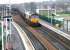 EWS 66229 has just crossed the bridge over the A9 on the west side of Falkirk on 10 December 2004. The locomotive is about to run west through Camelon station with returning coal empties from Longannet power station bound for Hunterston import terminal. <br><br>[John Furnevel 10/12/2004]