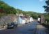 Although the short lived 1:35 branch from Portpatrick station to the Harbour was closed as early as 1868, a section of embankment and two bridge abutments still survive on Main St as seen here. This view is looking up the hill towards the site of the station where this road and the branch met again. <br><br>[Mark Bartlett 22/05/2011]